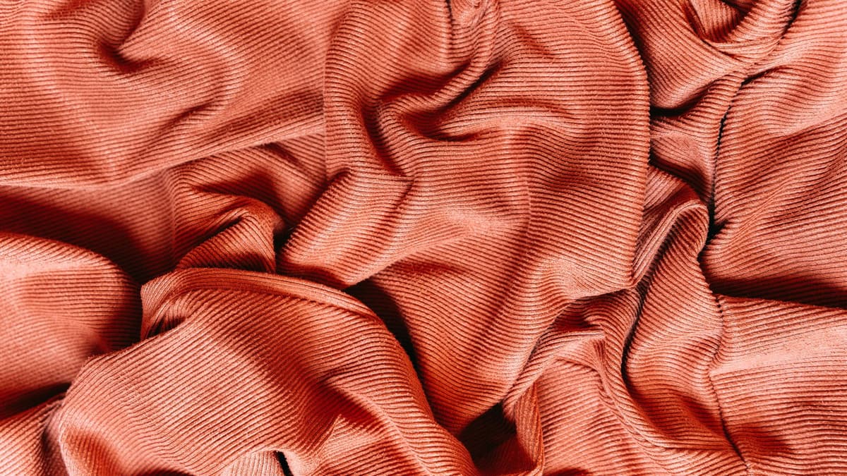 Close-up of red ribbed fabric showing its knit texture